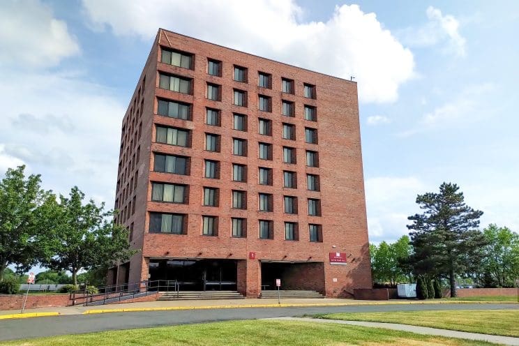 Large dormitory building in depicting the property listed at 1 Notre Dame Drive. 